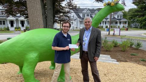 CEO Neil Gordon and scholarshp recipient Ajax Benander at Discovery Museum with Bessie the Dinosaur