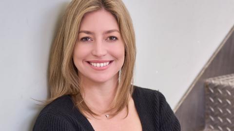 headshot of a woman sitting in stairs
