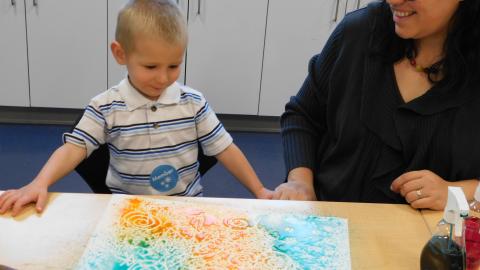 A boy looks at resist spray art