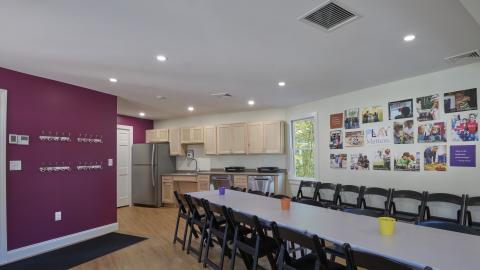 an interior view of a room with a long table with chairs