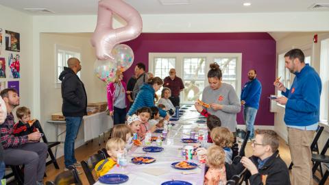a group of adults and their children at a child's birthday party
