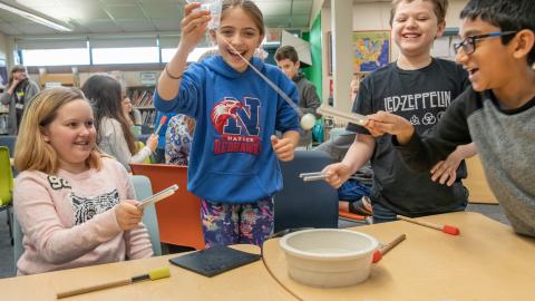 four students participate in a fun STEM workshop on sound