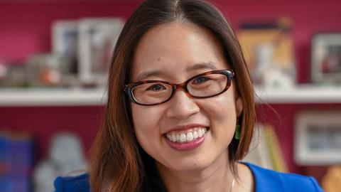 woman with brown glasses looking ahead