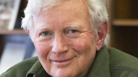 man with gray hear looking at camera