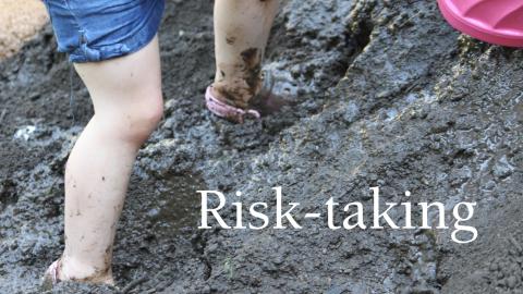 a youngster's legs and feet are shown close up, climbing a muddy hill