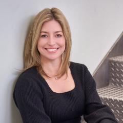 headshot of a woman sitting in stairs
