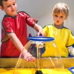 two children explore a water exhibit