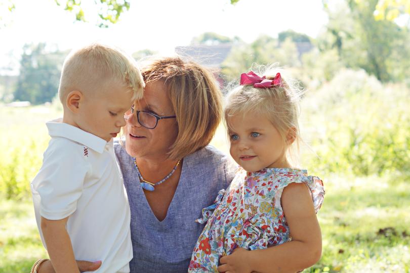 a grandmother speaks with her two grandchildren