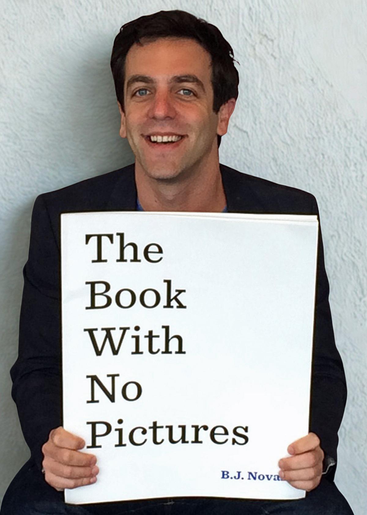 a man holds a book in front of him