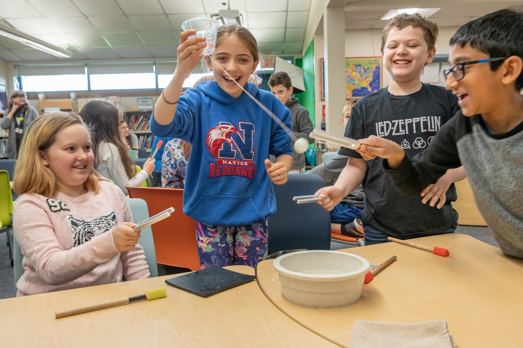 four students participate in a fun STEM workshop on sound