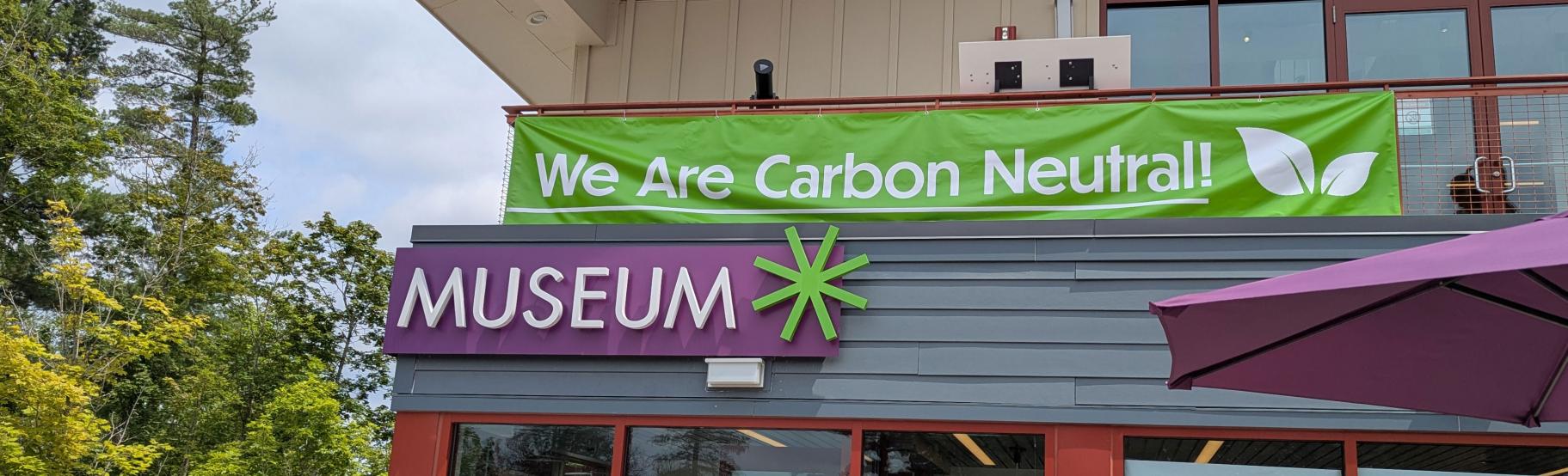 a banner on a building says, "We Are Carbon Neutral!"
