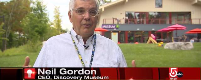 CEO Neil Gordon stands in front of the Museum while being filmed for a local TV station
