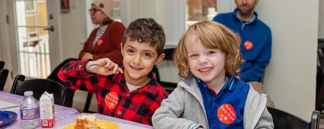 two boys eat cake at a birthday party